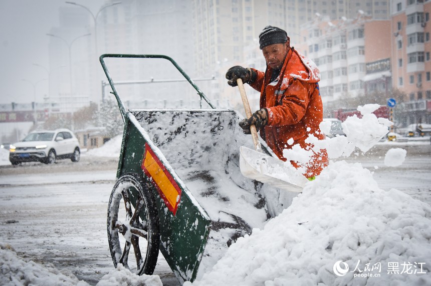 環(huán)衛(wèi)工人正在清理道路積雪。人民網(wǎng)記者 蘇靖剛攝
